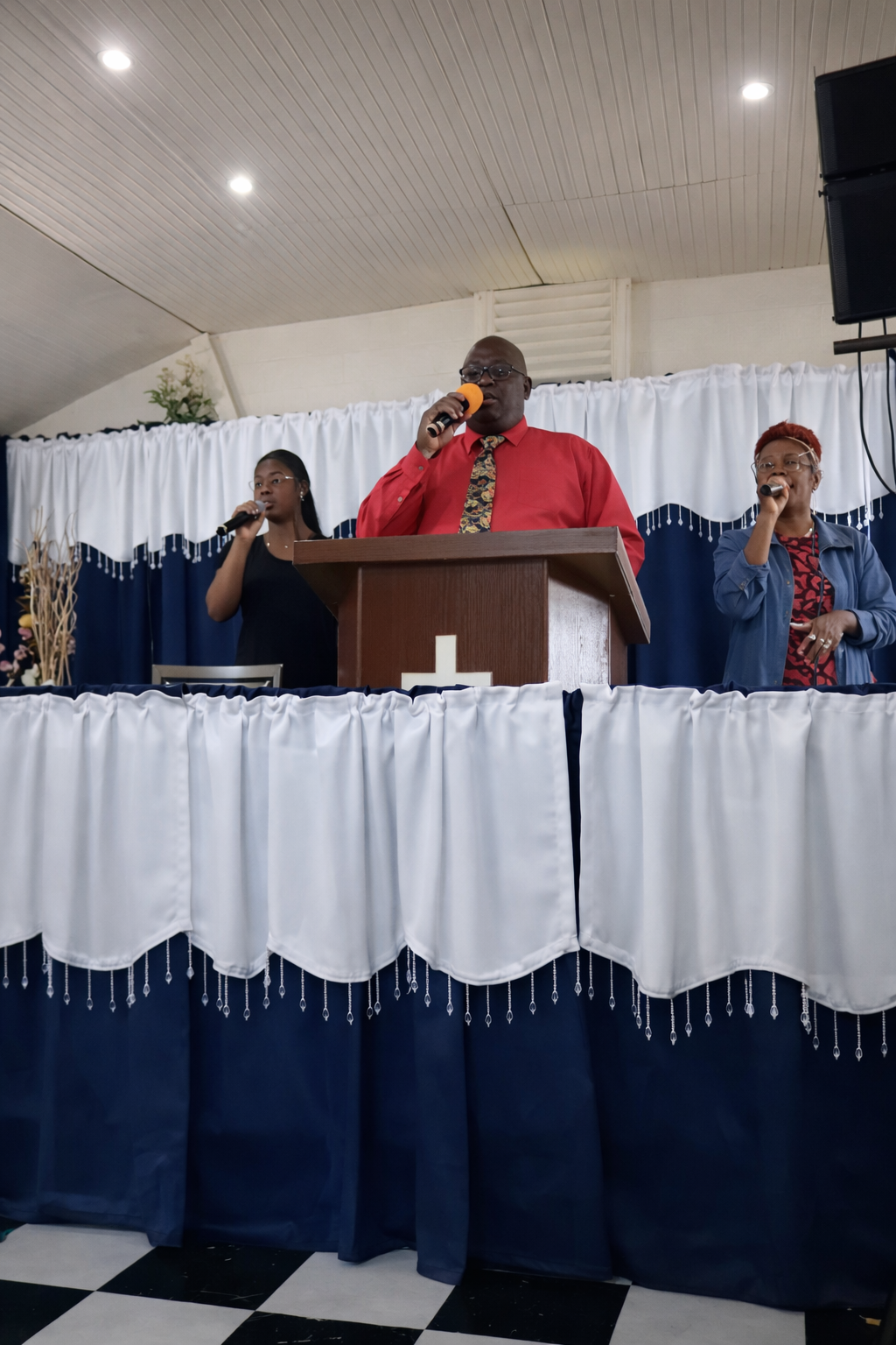 Pastor Jack preaching with choir